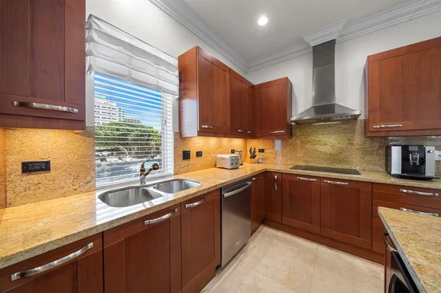 a living room with furniture kitchen area and a chandelier