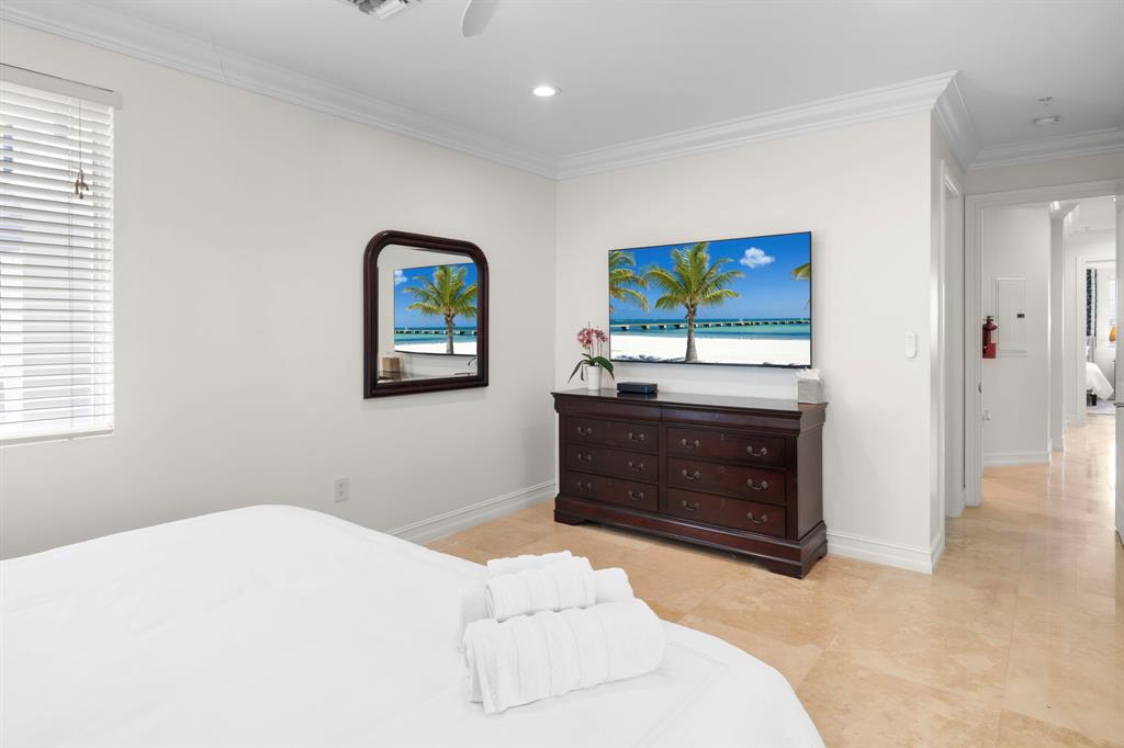 514 North Birch Road Fort Lauderdale, FL 33304 - Photo 26 of 78 a bedroom with a bed and a fireplace