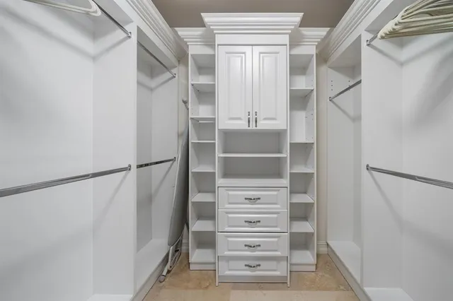 a view of a balcony with chairs and potted plants