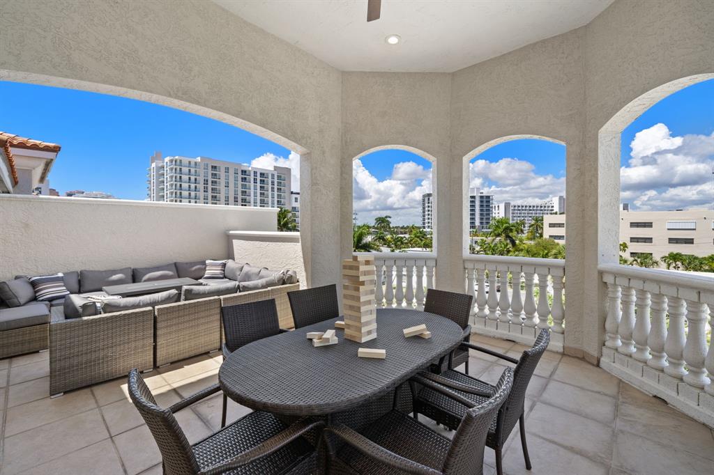 514 North Birch Road Fort Lauderdale, FL 33304 - Photo 56 of 78 a dining room with furniture a rug and a floor to ceiling window