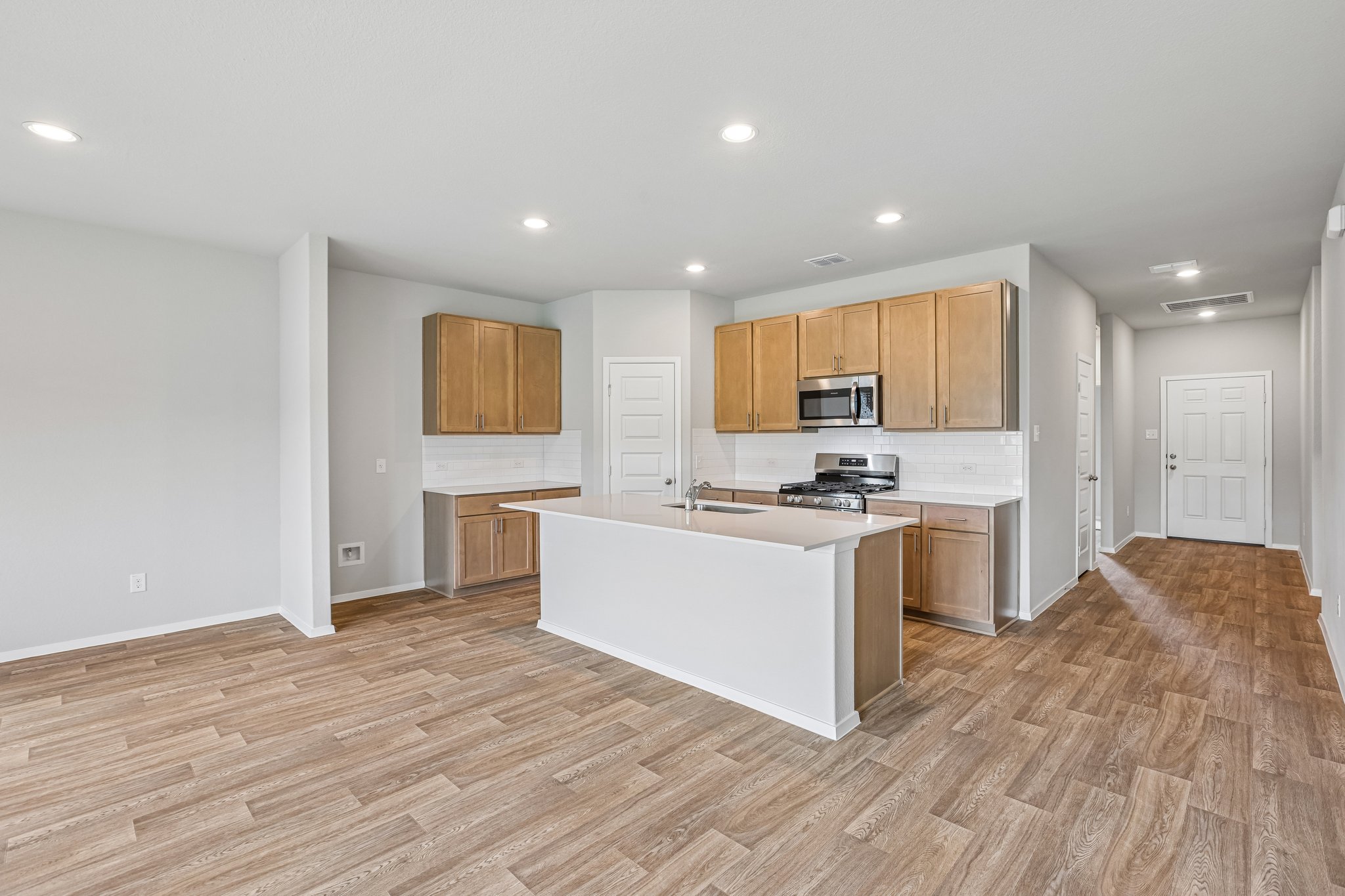 5513 Sacra Cove Austin, TX 78747 - Photo 11 of 37 a kitchen with a refrigerator and a stove top oven
