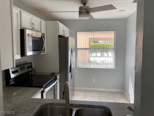 a kitchen with a refrigerator a sink and cabinets