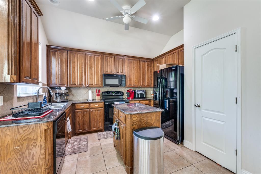 8233 Edgepoint Trail Fort Worth, TX 76053 - Photo 11 of 36 a kitchen with stainless steel appliances granite countertop a refrigerator stove and sink