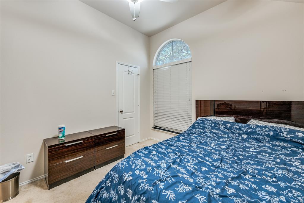 8233 Edgepoint Trail Fort Worth, TX 76053 - Photo 27 of 36 a bedroom with a bed and a lamp on table