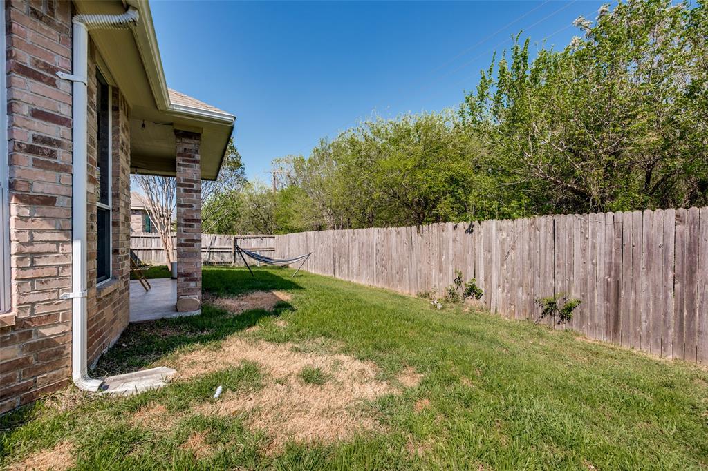 8233 Edgepoint Trail Fort Worth, TX 76053 - Photo 33 of 36 a view of backyard with wooden fence and large trees