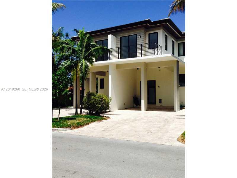 472 Fernwood Road, Unit 472 Key Biscayne, FL 33149 - Photo 3 of 8 a yellow house with trees in front of it