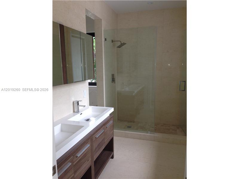 472 Fernwood Road, Unit 472 Key Biscayne, FL 33149 - Photo 6 of 8 a bathroom with a sink a shower and a mirror
