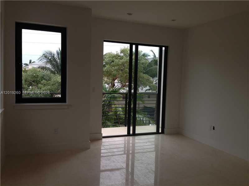 472 Fernwood Road, Unit 472 Key Biscayne, FL 33149 - Photo 7 of 8 a view of an empty room with windows