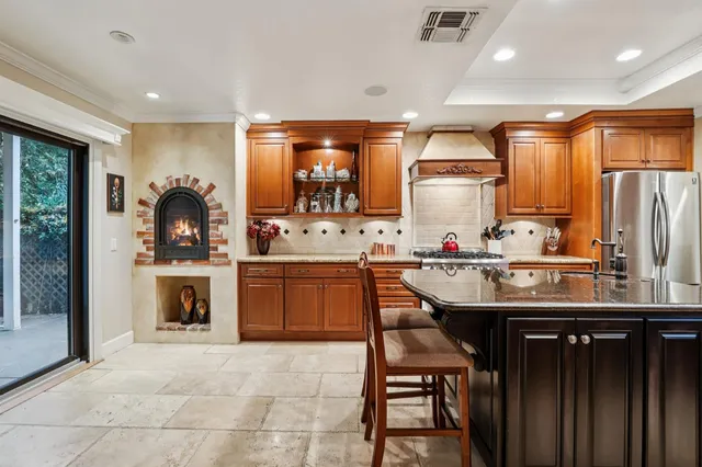 a kitchen with a sink a stove and chairs