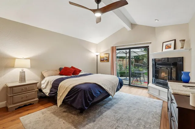 a spacious bedroom with a bed a couch and a fireplace