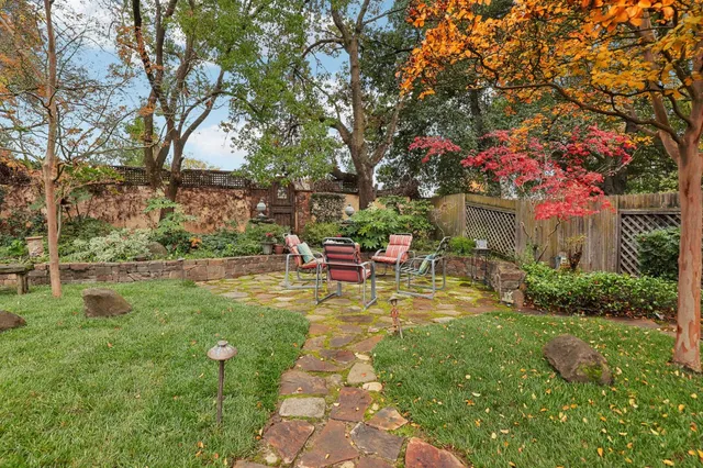 a view of yard with swimming pool and green space