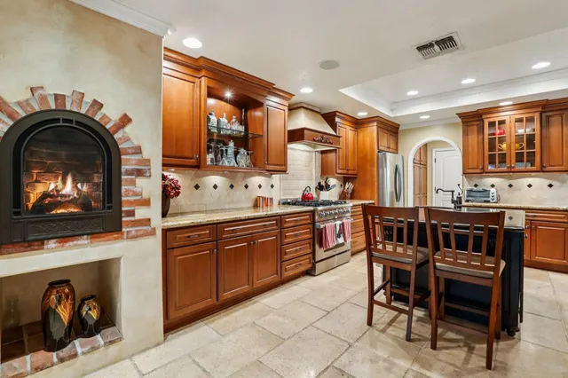 a open kitchen with stainless steel appliances granite countertop a stove and a sink
