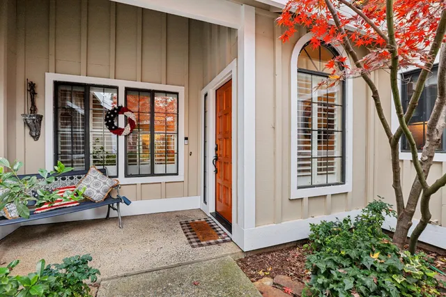 a front view of a house with outdoor seating and plants