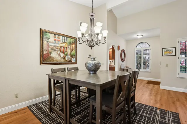 a view of a dining room with furniture and chandelier