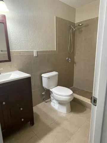 a bathroom with a toilet a sink and shower