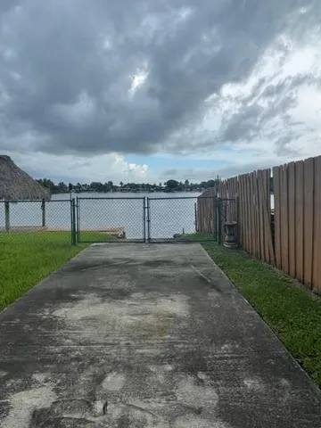 a view of a yard with wooden fence