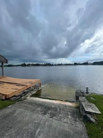 a view of a lake with houses in the back
