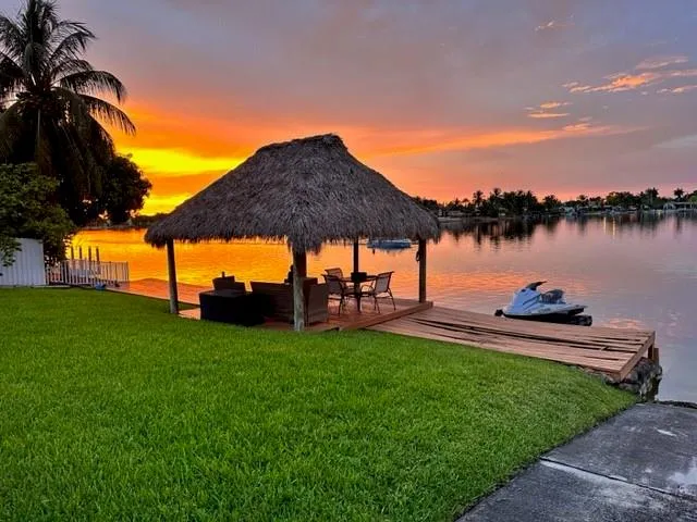 a view of a lake with a garden and a sitting area