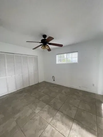 a view of a livingroom with a ceiling fan and window