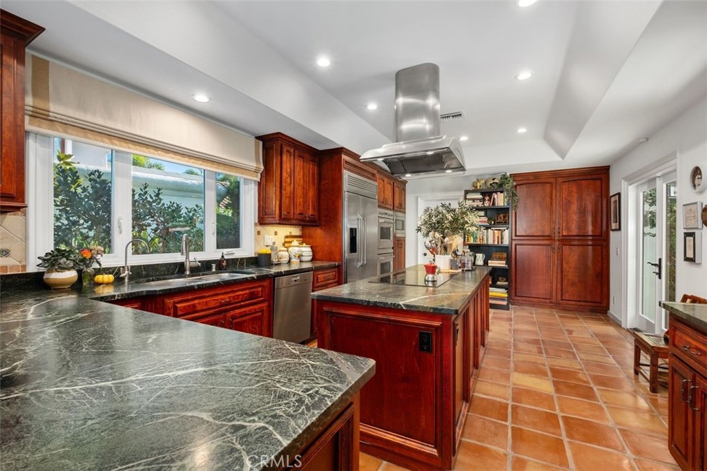12 Terraza Del Mar Dana Point, CA 92629 - Photo 21 of 52 a kitchen with stainless steel appliances granite countertop a stove a refrigerator a oven and white cabinets with wooden floor