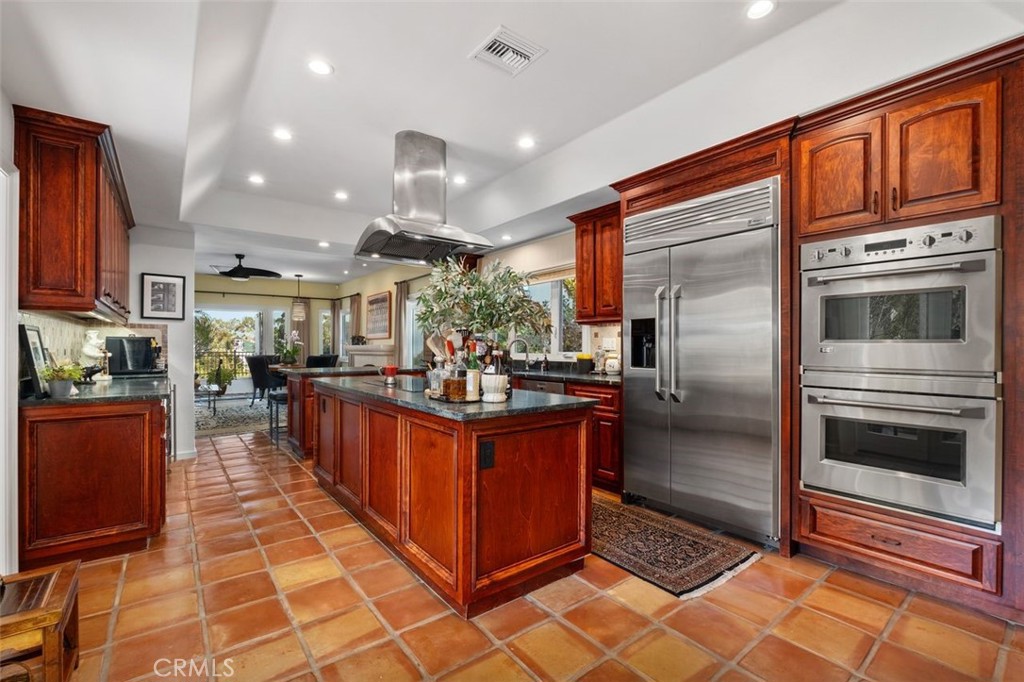 12 Terraza Del Mar Dana Point, CA 92629 - Photo 23 of 52 a kitchen with stainless steel appliances granite countertop a refrigerator a oven a sink and blue cabinets