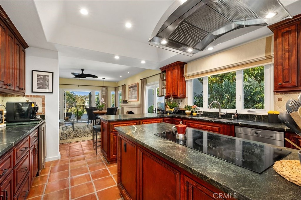 12 Terraza Del Mar Dana Point, CA 92629 - Photo 24 of 52 a large kitchen with kitchen island granite countertop a large window and stainless steel appliances