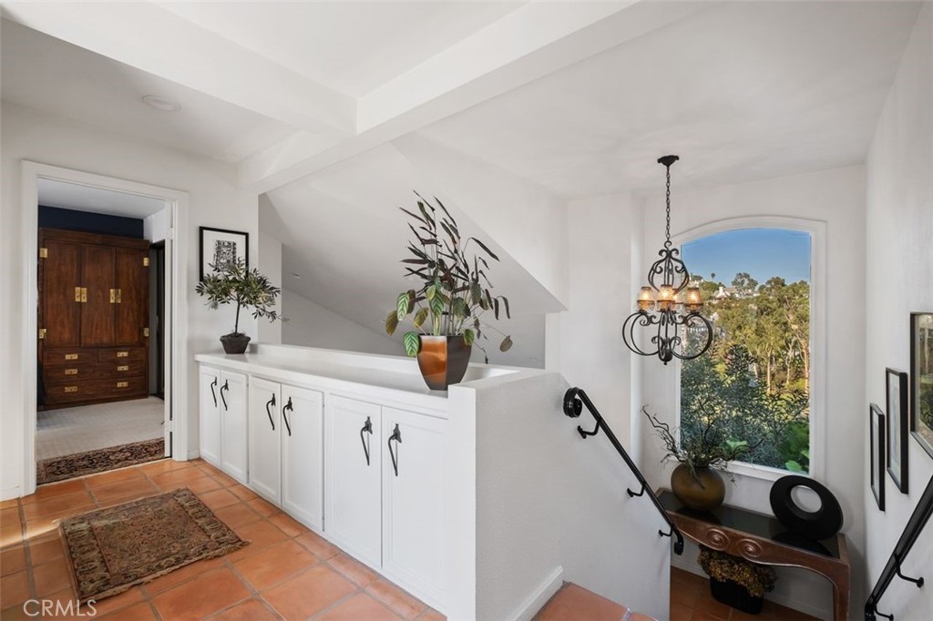12 Terraza Del Mar Dana Point, CA 92629 - Photo 27 of 52 a hallway with a chandelier