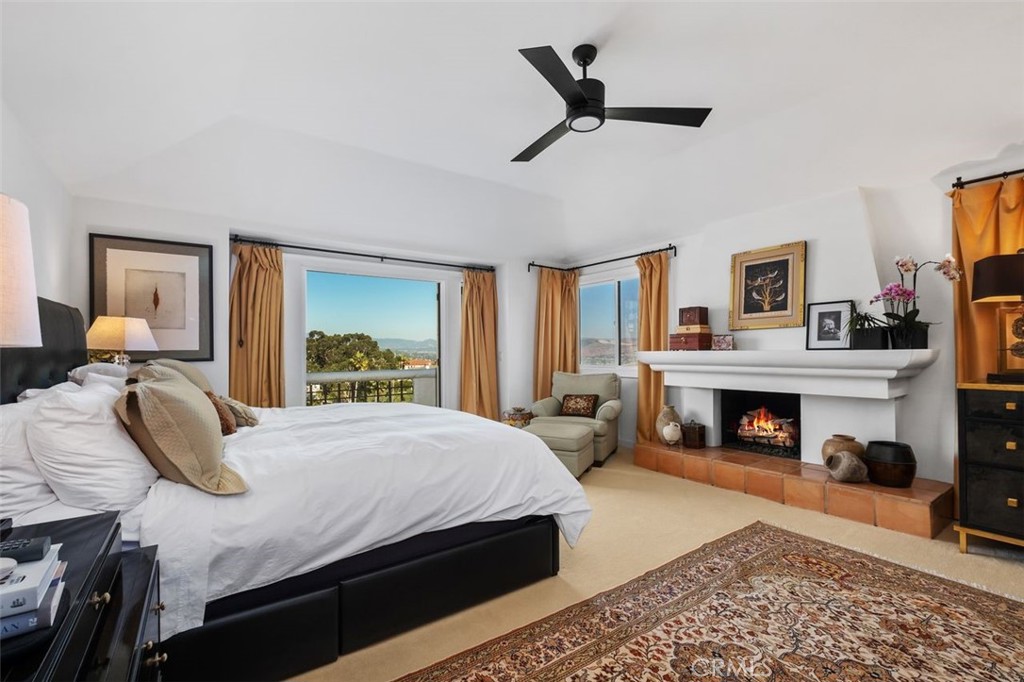 12 Terraza Del Mar Dana Point, CA 92629 - Photo 28 of 52 a bedroom with a bed and a fireplace