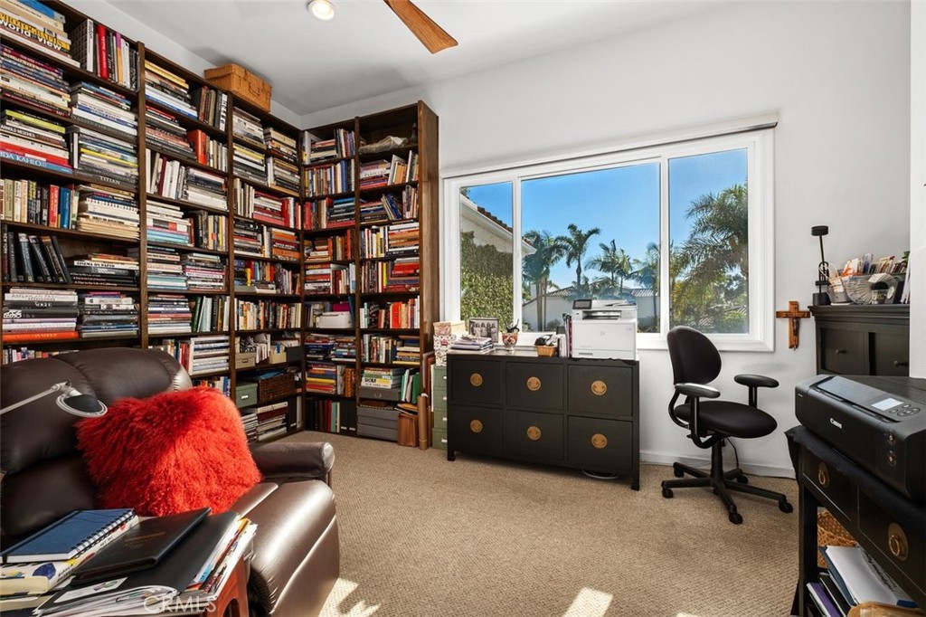 12 Terraza Del Mar Dana Point, CA 92629 - Photo 35 of 52 a living room with furniture a bookshelf and a large window