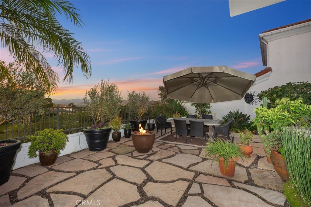 12 Terraza Del Mar Dana Point, CA 92629 - Photo 9 of 52 a view of a patio with table and chairs under an umbrella