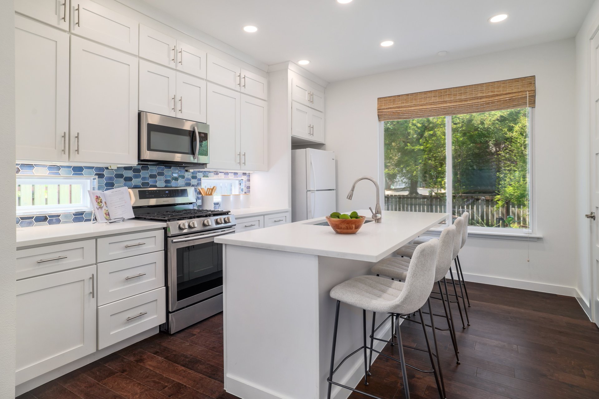 3911 Duval Street, Unit 2 Austin, TX 78751 - Photo 11 of 39 a kitchen with stainless steel appliances a stove a sink a microwave a refrigerator and cabinets