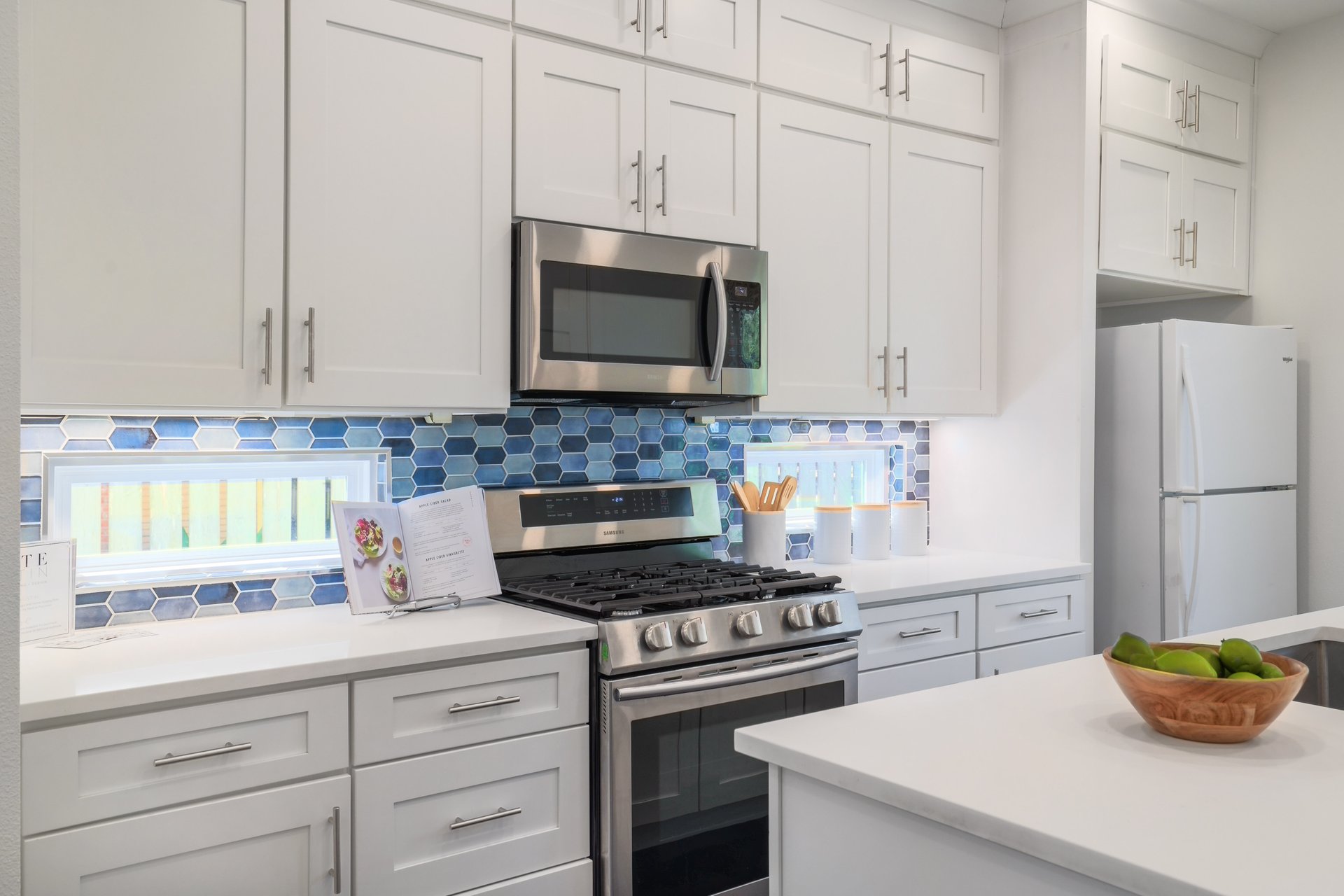 3911 Duval Street, Unit 2 Austin, TX 78751 - Photo 12 of 39 a kitchen with granite countertop white cabinets and stainless steel appliances