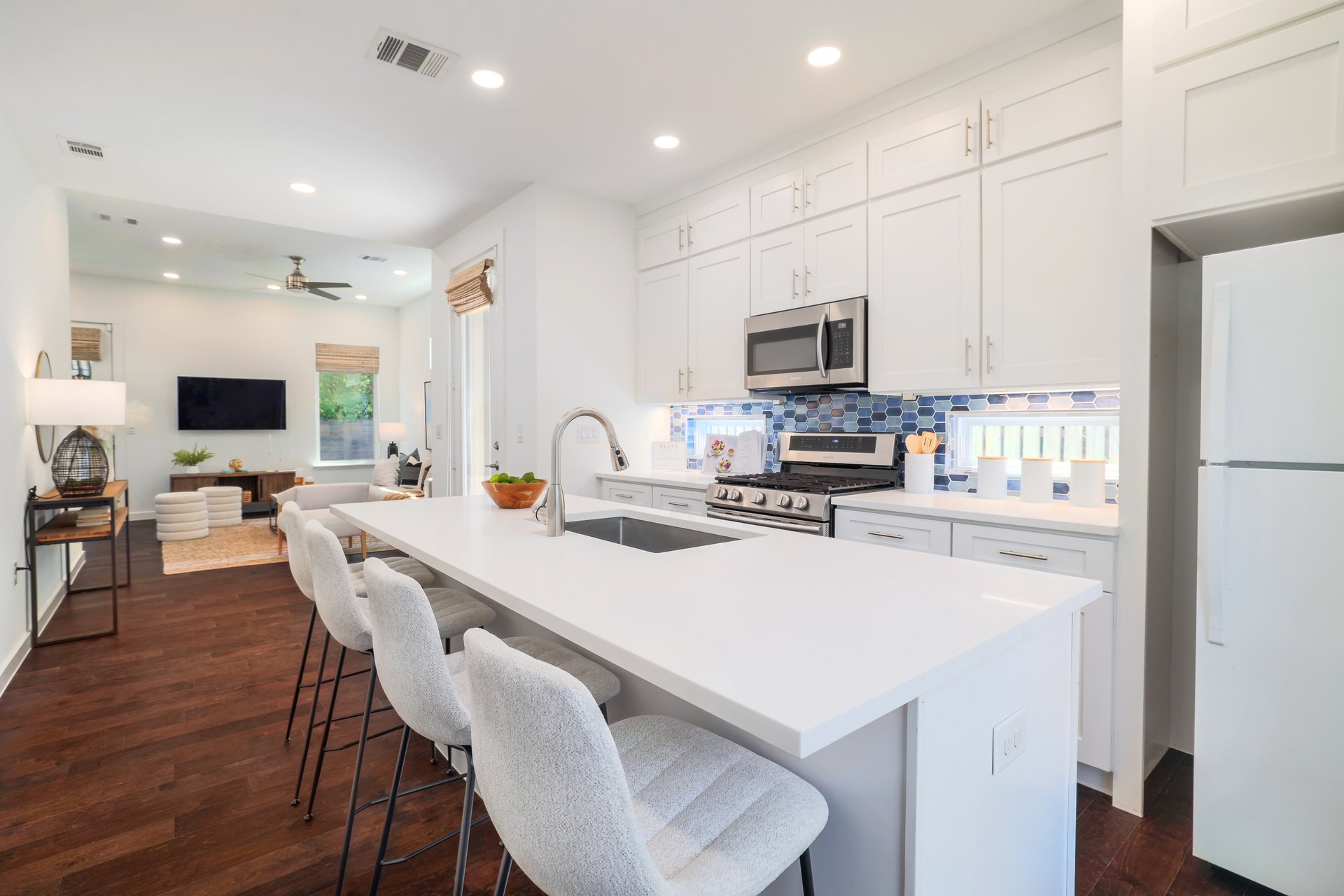 3911 Duval Street, Unit 2 Austin, TX 78751 - Photo 14 of 39 a kitchen with a dining table chairs refrigerator and microwave