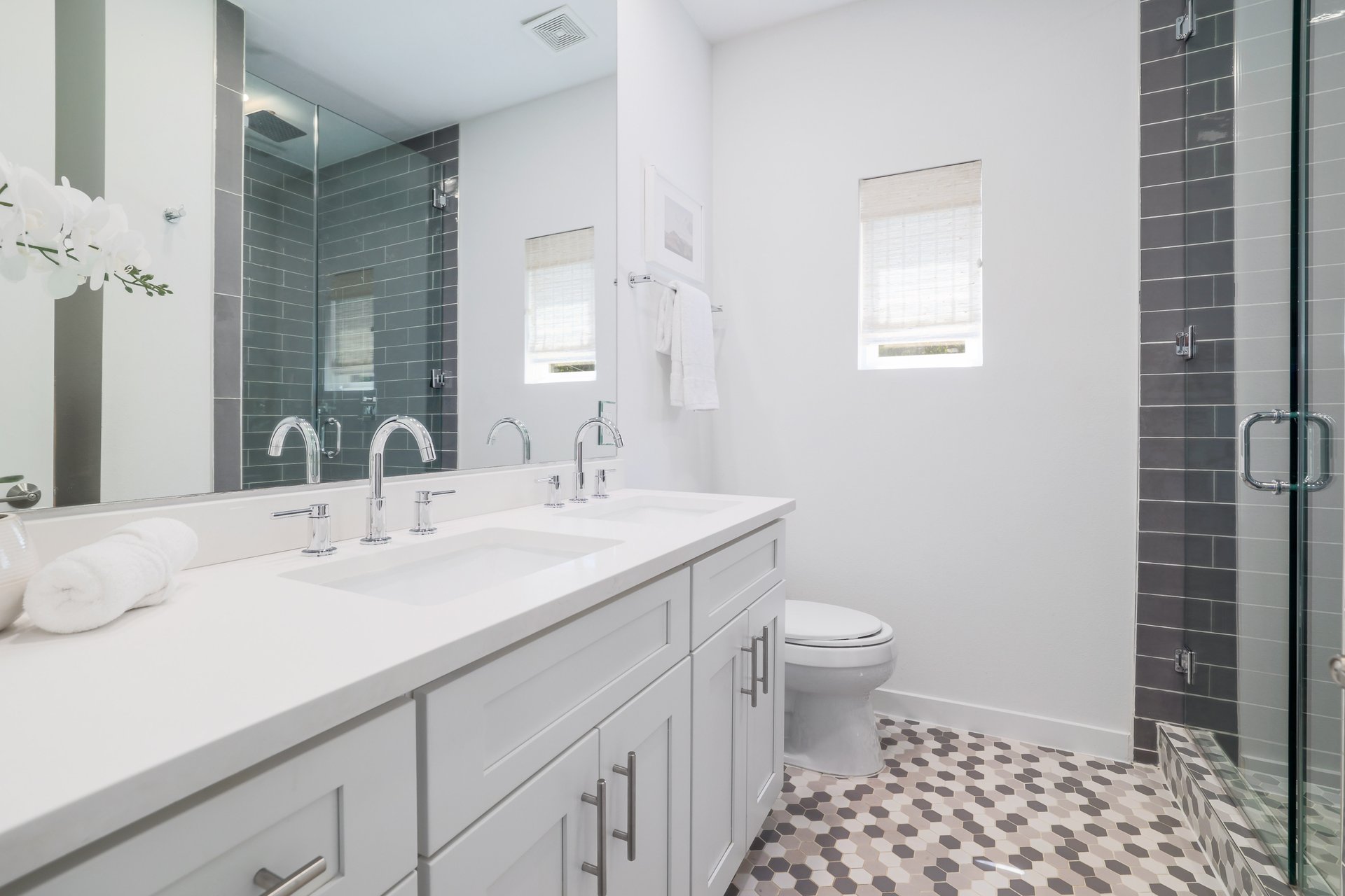 3911 Duval Street, Unit 2 Austin, TX 78751 - Photo 20 of 39 a bathroom with a sink a toilet a shower and a mirror