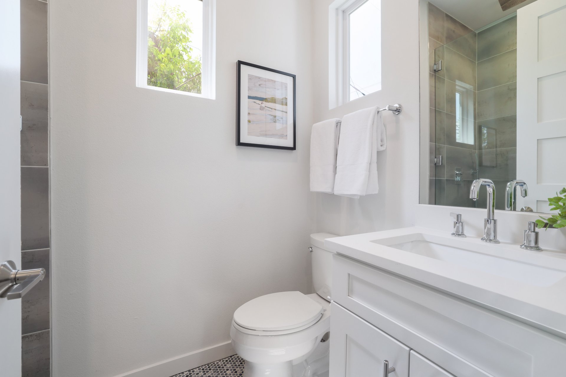 3911 Duval Street, Unit 2 Austin, TX 78751 - Photo 24 of 39 a bathroom with a toilet sink and mirror