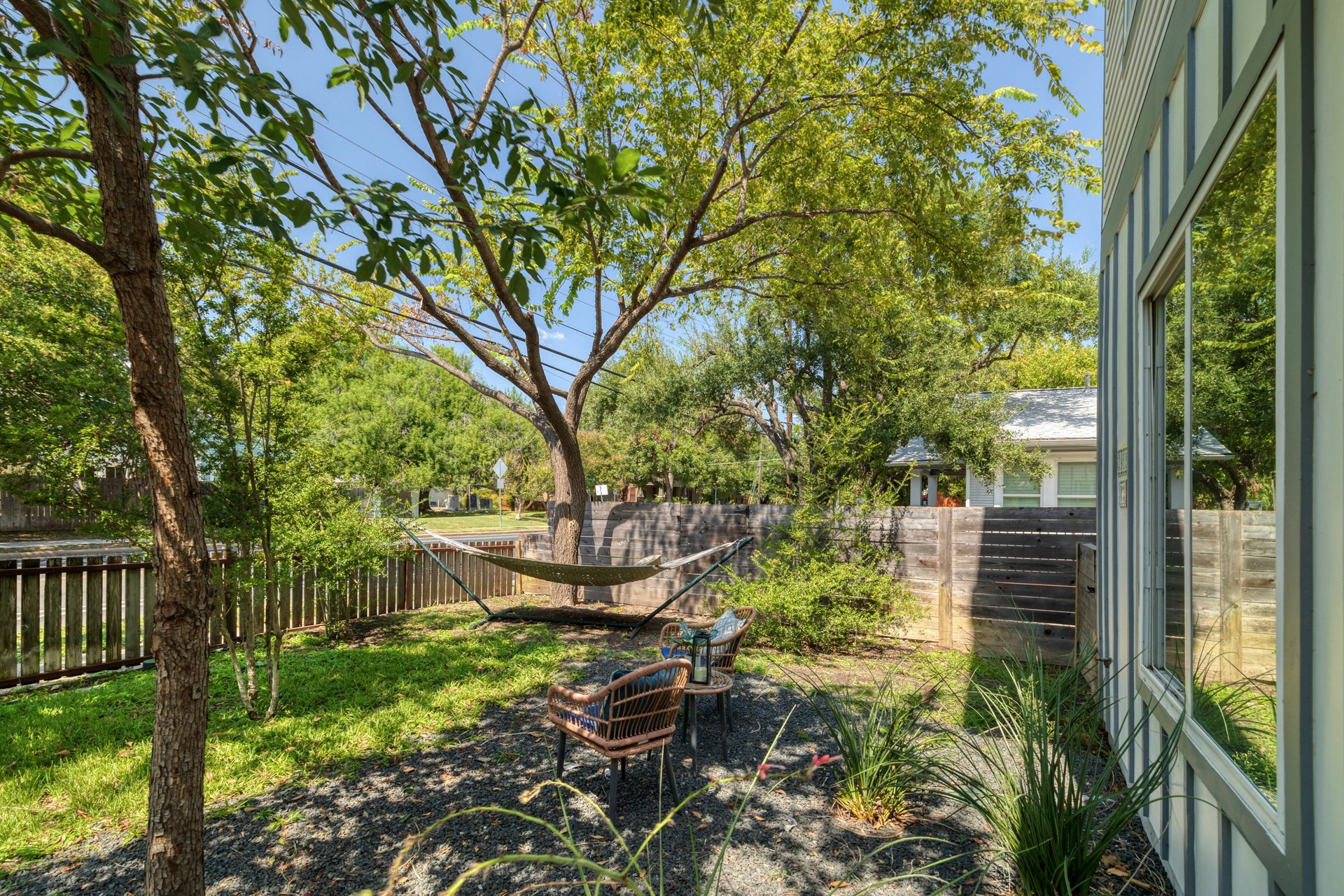 3911 Duval Street, Unit 2 Austin, TX 78751 - Photo 28 of 39 a view of a garden with plants and large trees