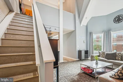 a living room with furniture and a stair