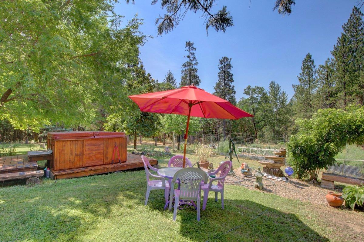 770 Hitching Post Road Grants Pass, OR 97526 - Photo 24 of 29 a view of backyard with seating space and trees