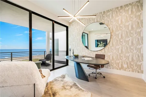 a living room with furniture a large window and a table