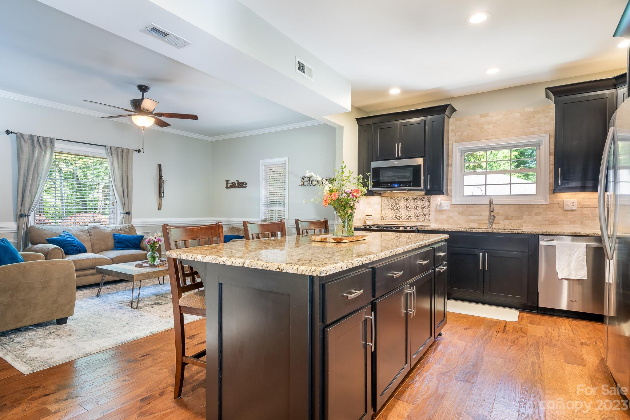 3119 Lake Shore Road South Denver, NC 28037 - Photo 13 of 35 a kitchen with stainless steel appliances granite countertop a sink stove and wooden floor
