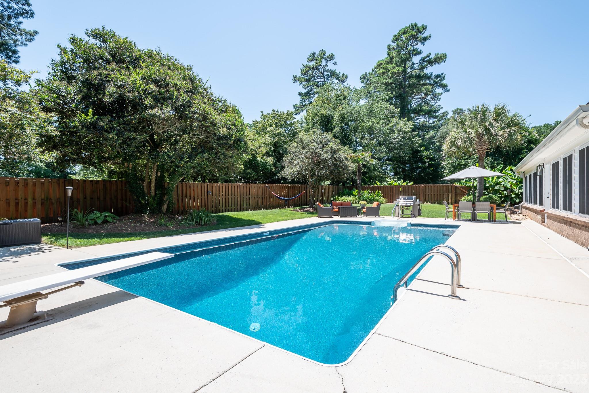 3119 Lake Shore Road South Denver, NC 28037 - Photo 2 of 35 a view of a swimming pool with a patio and a yard