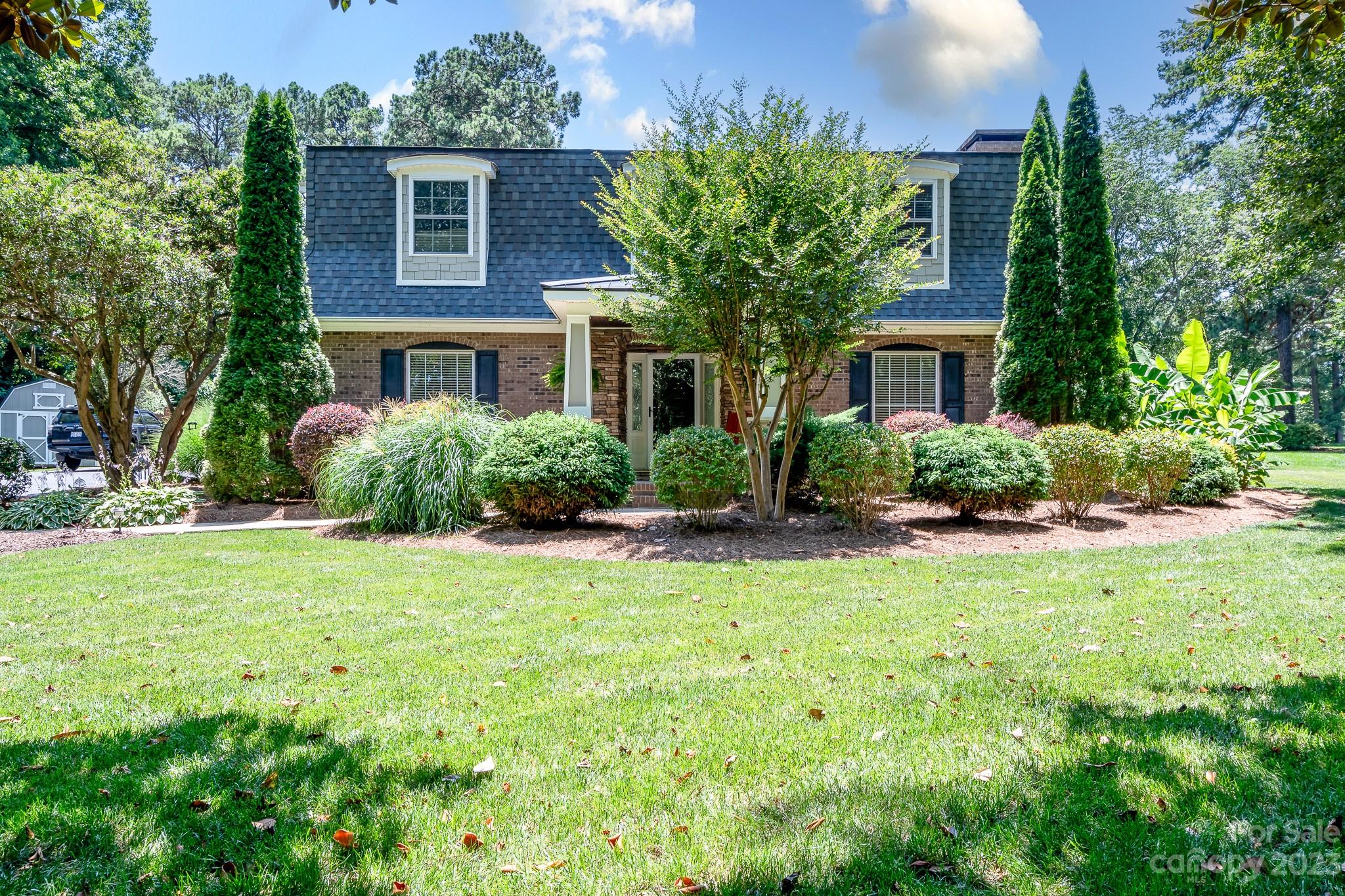 3119 Lake Shore Road South Denver, NC 28037 - Photo 8 of 35 a front view of a house with a yard and potted plants