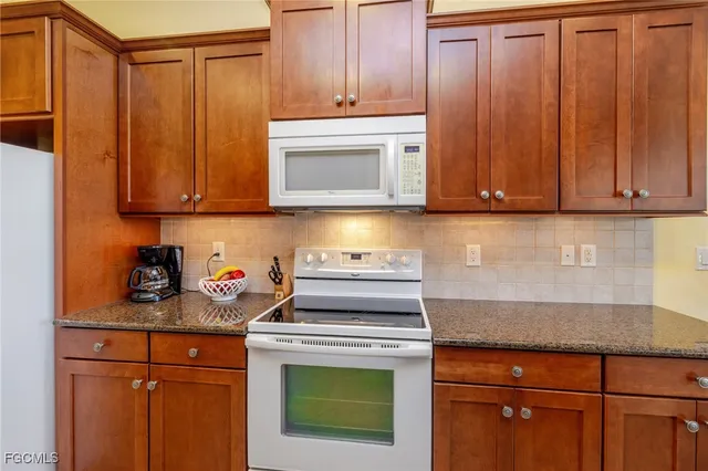 a kitchen with a stove and cabinets
