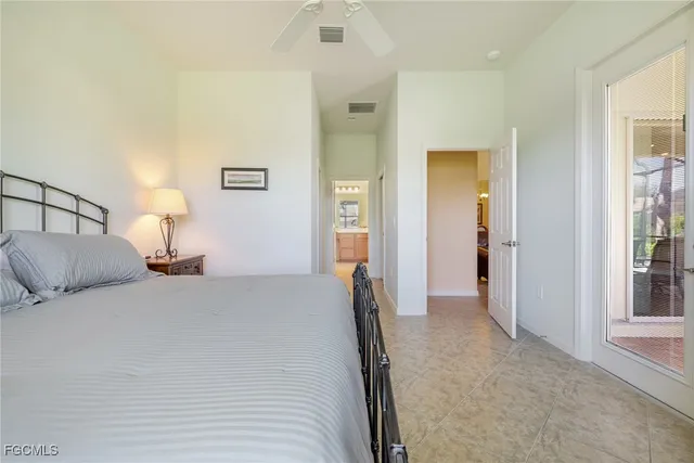 a bedroom with a bed and a lamp