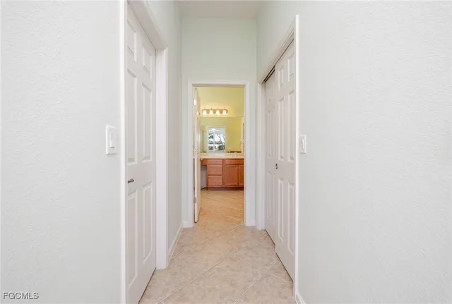 a view of a hallway with a white walls and a bathroom