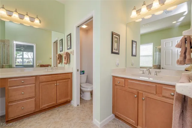 a spacious bathroom with a granite countertop sink mirror and toilet