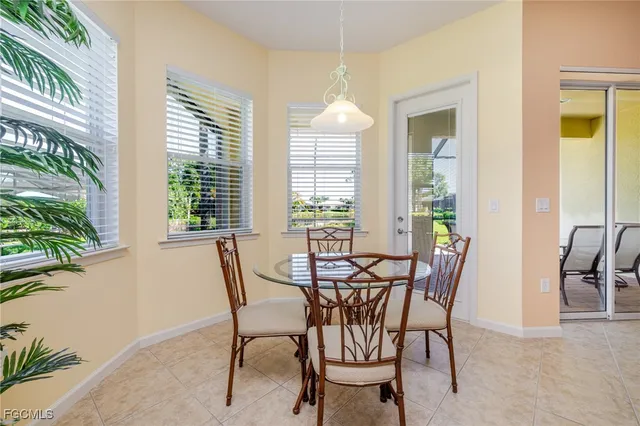 a view of a dining room with furniture and a potted plant