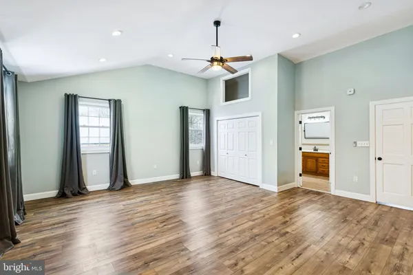 a view of a livingroom with wooden floor and staircase
