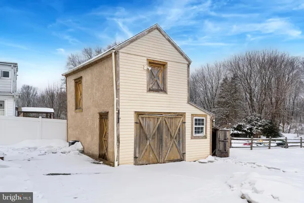 a view of a house with a yard covered in snow
