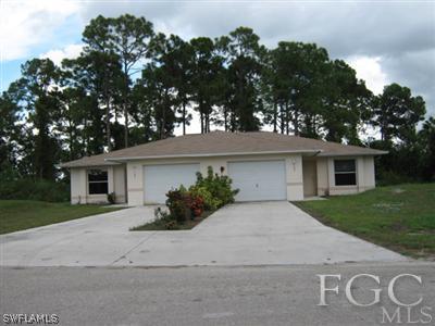 101 Meadow Road Lehigh Acres, FL 33973 - Photo 1 of 4 front view of a house with a yard